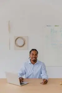 South African small business owner working on laptop managing business tools
