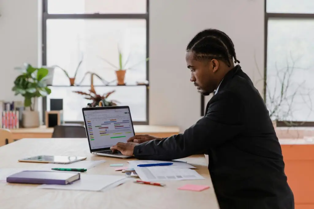 South African business owner managing customers on laptop
