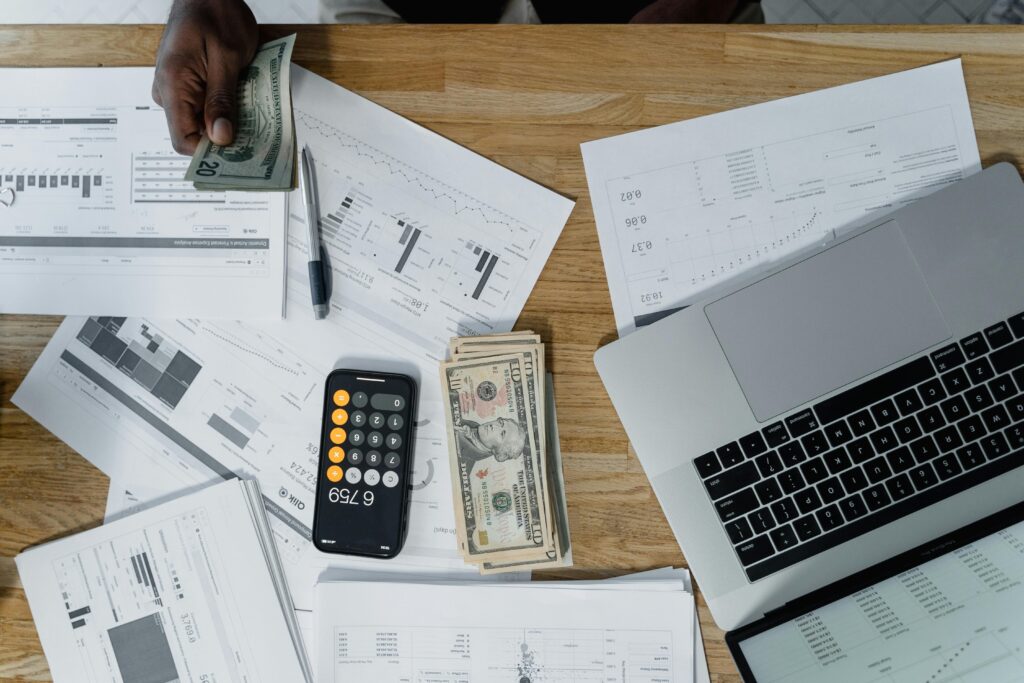 South African small business owner processing payroll on computer