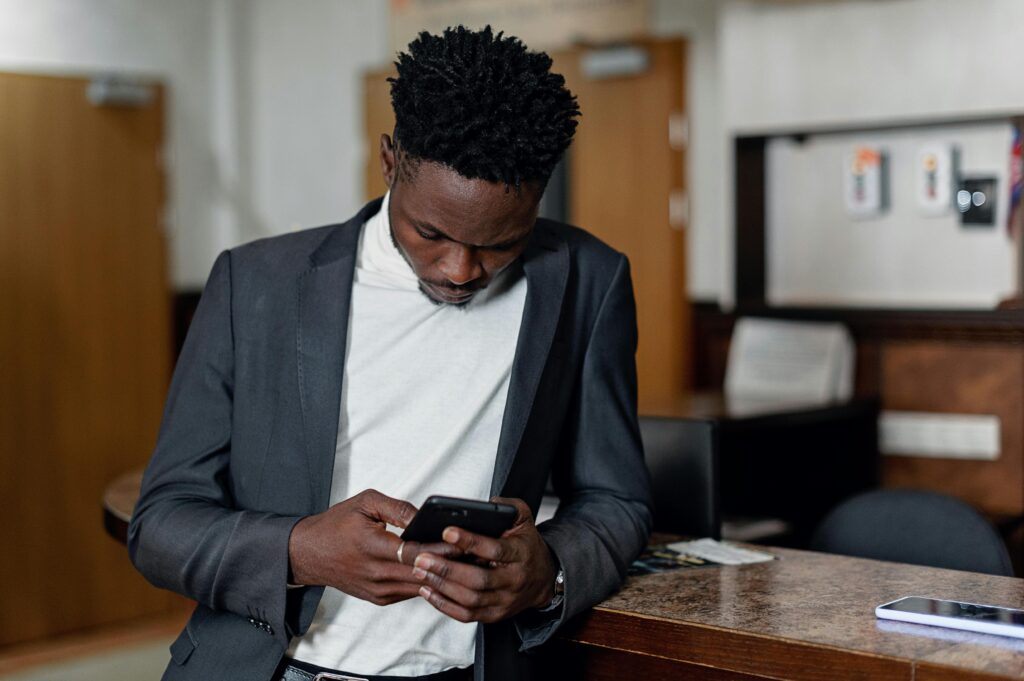 South African business owner reading marketing email on smartphone