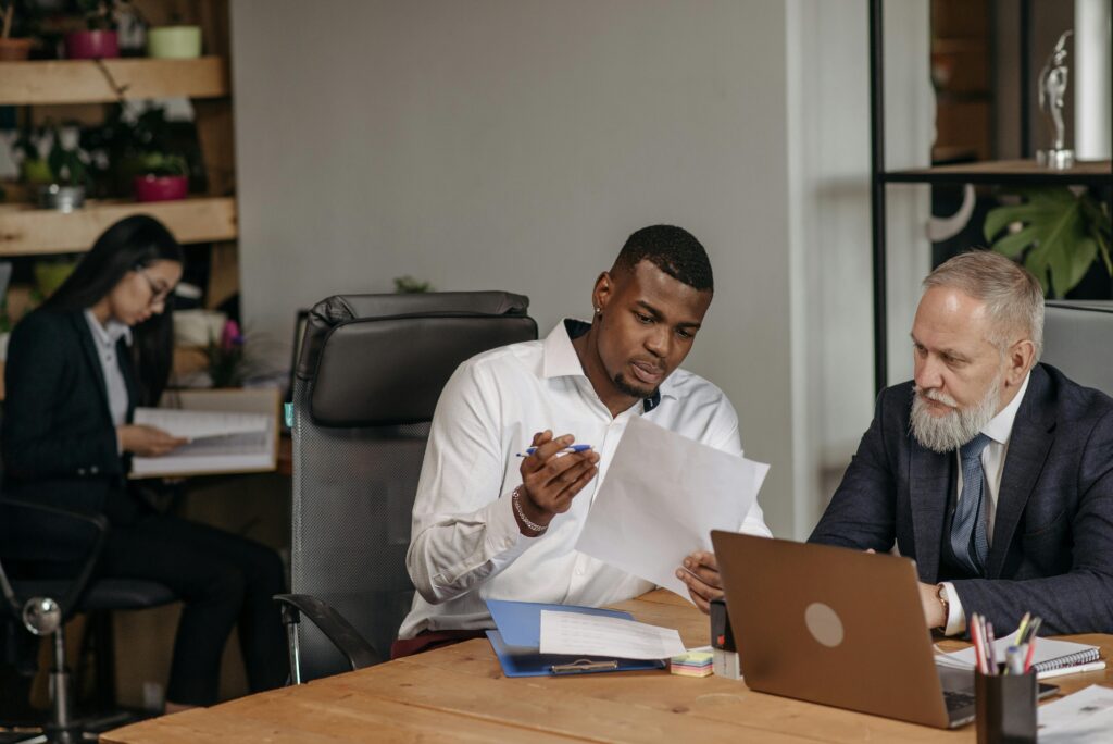 South African business owner managing employees using HR software on laptop