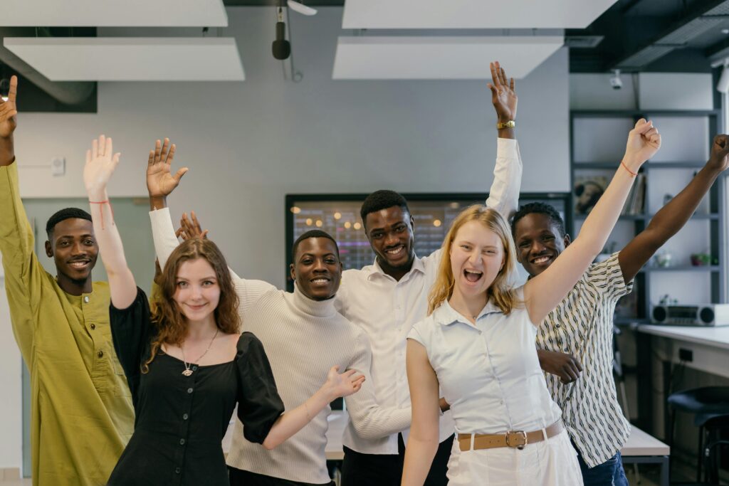 Happy South African employees in office managed with HR payroll software