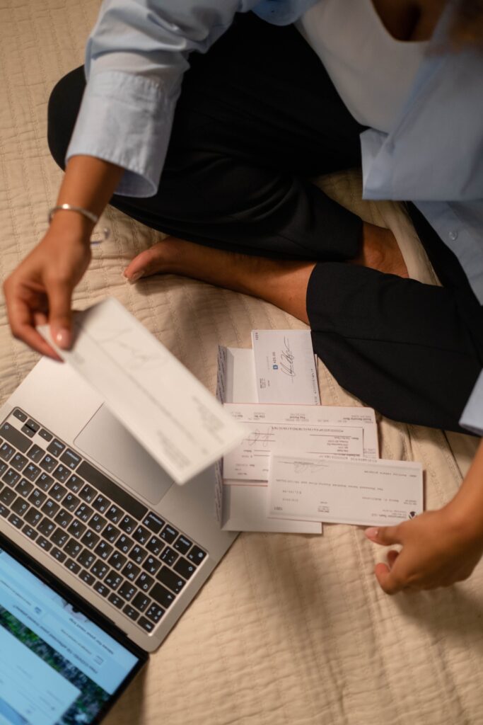 South African service business owner managing invoices on laptop