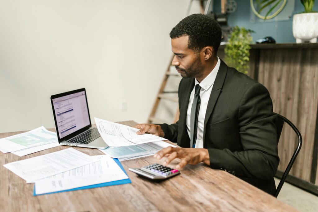 South African entrepreneur reviewing business finances on laptop