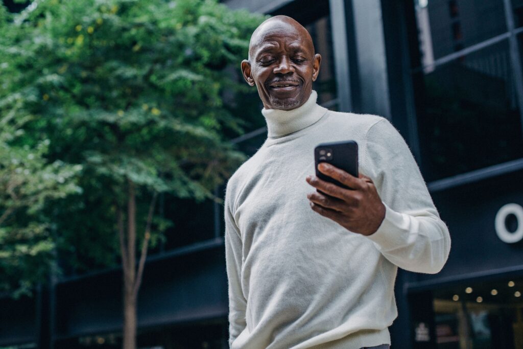 South African entrepreneur managing business social media on smartphone